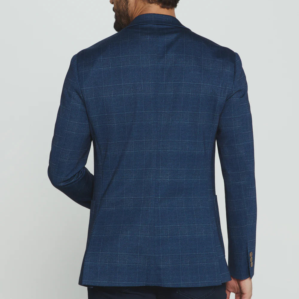 Man wearing a blue checkered suit jacket on a white background
