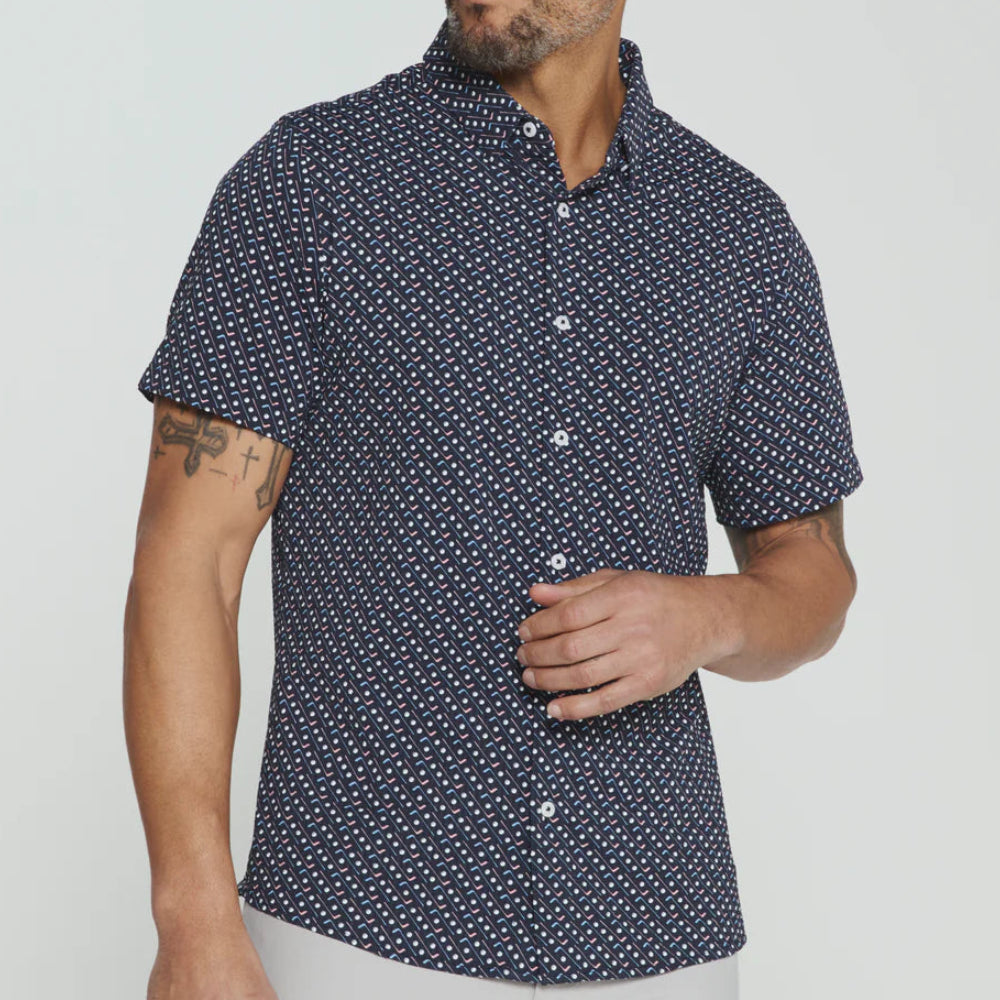 Man wearing a navy short-sleeve shirt with white pattern on a light gray background