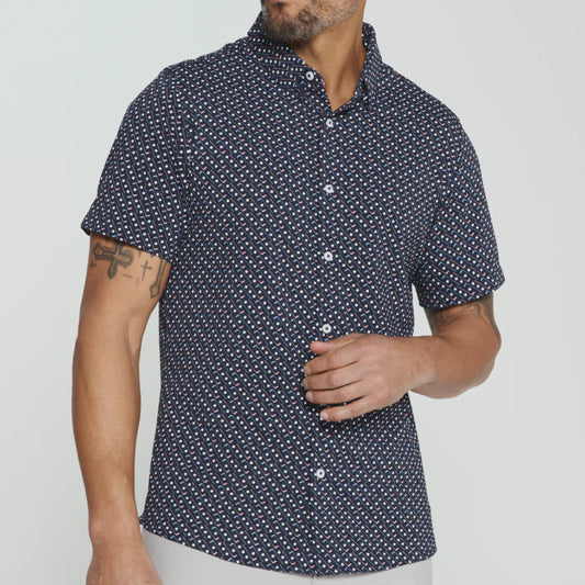 Man wearing a navy short-sleeve shirt with white pattern on a light gray background